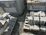a pile of bricks sitting on the ground next to pallets