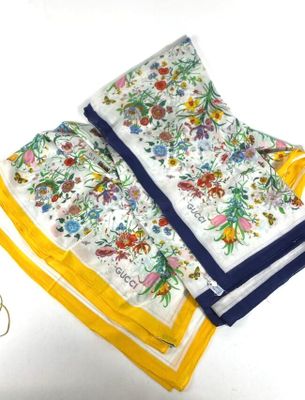 three napkins with a yellow border and a white and blue border