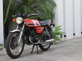 a red motorcycle parked on the side of the road