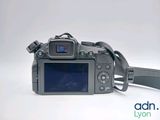 a camera with a strap attached to it ' s body