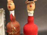 three wine bottles that look like people in hats and ties