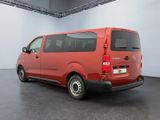 the red van is parked in a large room with a white wall