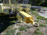 a yellow tow truck that is parked on the side of the road