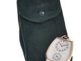 an image of a pocket watch with a leather case on a white background