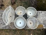 four white plastic bowls sitting on top of a stone slab