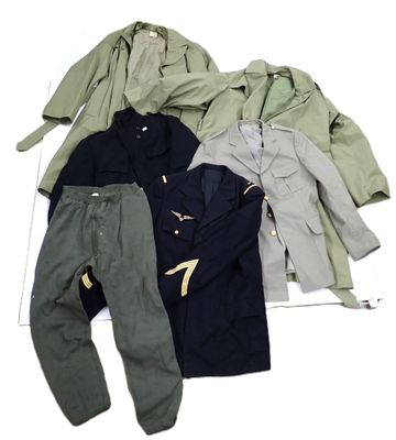 several jackets and pants are laid out on a white surface