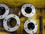four different types of pipe fittings on a yellow surface