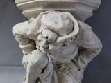 a statue of a man sitting on top of a pedestal