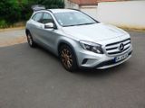 the mercedes gla suv is parked on the side of the road