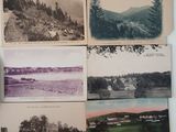 many old photos of a lake and mountains on the table