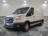the white van is parked on a checkered floor in a room