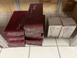 three boxes of wine sitting on top of a tiled floor next to each other