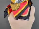 yellow, red, and blue scarf on a mannequin head