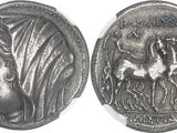 a close up of a silver coin with a woman on it