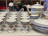 a lot of cups and saucers on the table