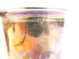 a close up of a glass with a mickey mouse design on it