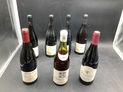 several bottles of wine are lined up in a row on a counter