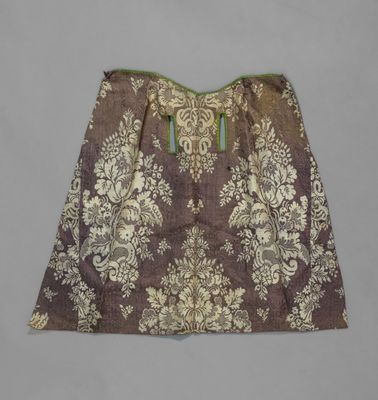 a close up of a brown and white skirt with a green trim