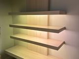 a wooden shelf that has been built into the wall