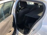 a white car with its door open and the door open