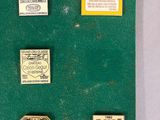 a lot of different types of badges on a green surface