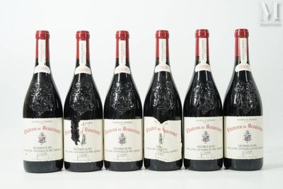 six bottles of wine are lined up in a row on a white surface