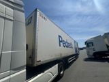 two semi trucks that are parked next to each other