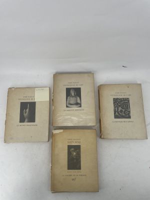 three old books sitting on top of a white table next to each other