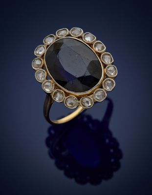 a sapphire and diamond ring, by person