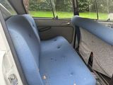 two seats in the back of a car with a mattress on it
