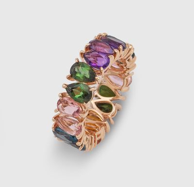 a close up of a ring with multi colored stones