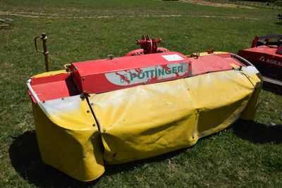 a yellow and red boat that is sitting in the grass