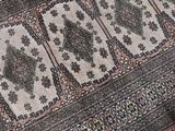 a cat that is sitting on a rug on the floor