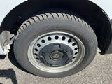 a close up of a flat tire on a white truck