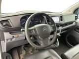 the interior of a car with a steering wheel and dashboard controls