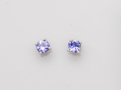 a pair of tanzanite earrings on a white background