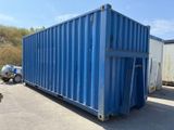 a blue container sitting in the middle of a parking lot
