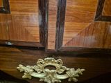 a wooden cabinet with a brass handle on it