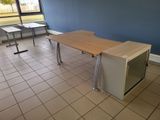a desk with a microwave on it in the corner of a room