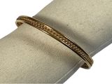 a close up of a gold bracelet on a napkin