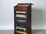 an image of a tall wooden cabinet with drawers on top of it