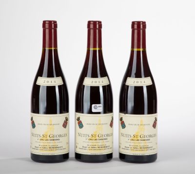 three bottles of wine sitting on top of a table next to each other