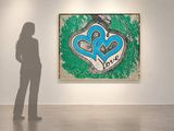 a woman that is standing in front of a painting