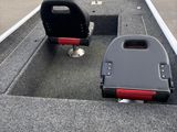 two seats on the back of a boat in a parking lot