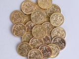 a pile of gold and silver coins on a white surface