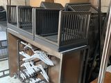 many boxes and crates on a table in a warehouse