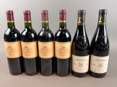 several bottles of wine are lined up on a table