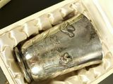 a silver flask sitting in a box on a table