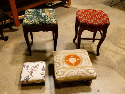 three small stools are lined up on the floor in a room