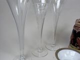 four empty wine glasses sitting on a table next to a bottle
